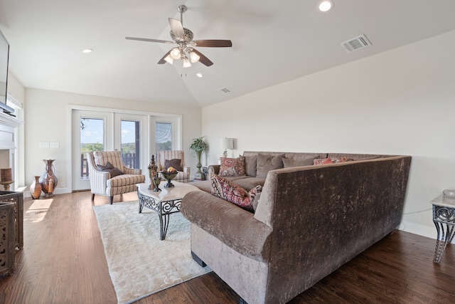 living room featuring ceiling fan, lofted ceiling, and wood-type flooring