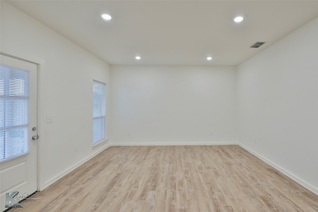 spare room with light hardwood / wood-style flooring