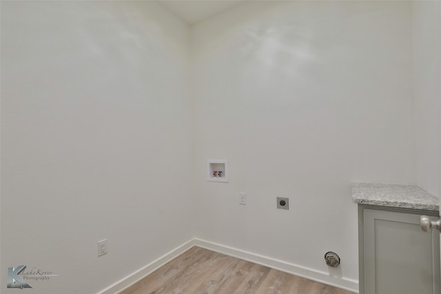 clothes washing area featuring light wood-type flooring, hookup for an electric dryer, and hookup for a washing machine