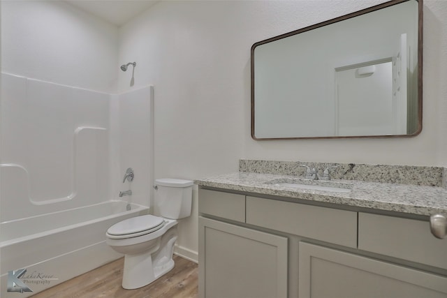 full bathroom featuring wood-type flooring, vanity, shower / bath combination, and toilet