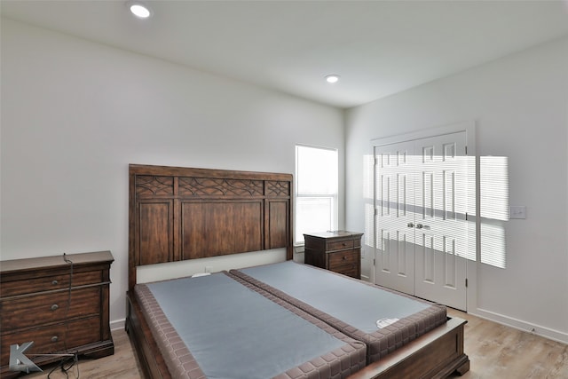 bedroom featuring multiple windows and light hardwood / wood-style floors