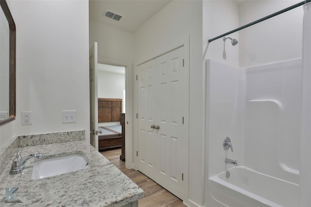 bathroom with shower / tub combo, vanity, and hardwood / wood-style floors