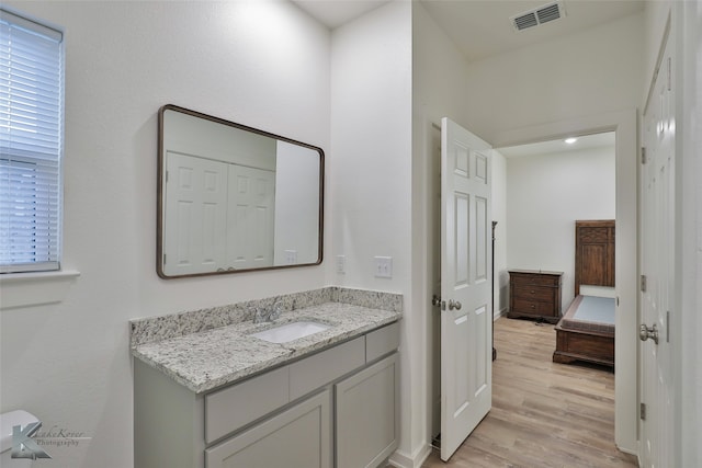 bathroom with vanity and hardwood / wood-style flooring