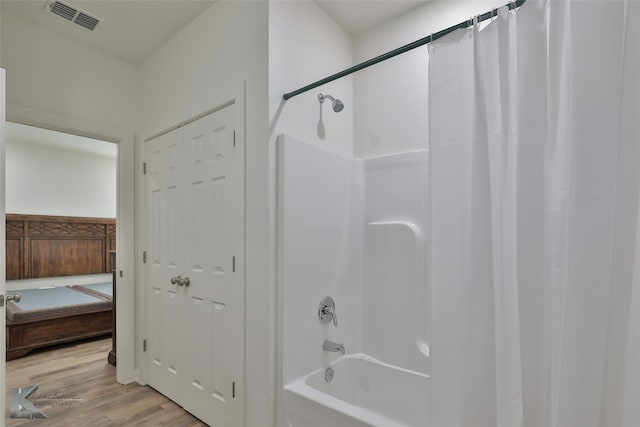 bathroom featuring shower / bath combo and hardwood / wood-style floors