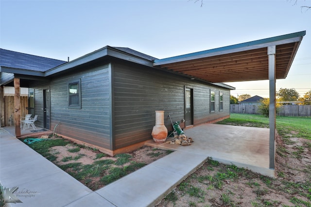 view of side of property featuring a patio