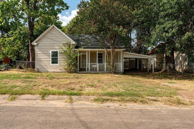 view of front of house featuring covered porch and a carport