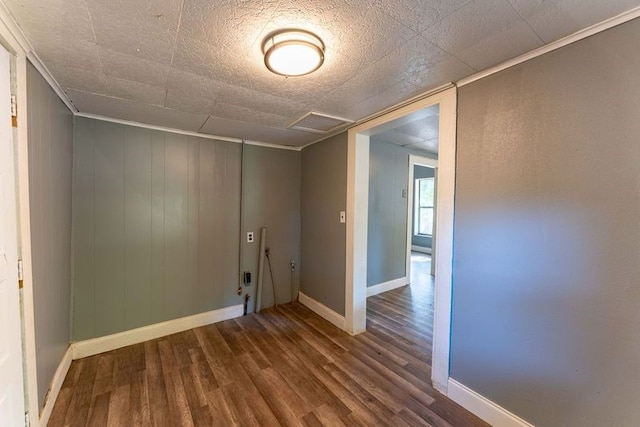 empty room with ornamental molding and hardwood / wood-style flooring