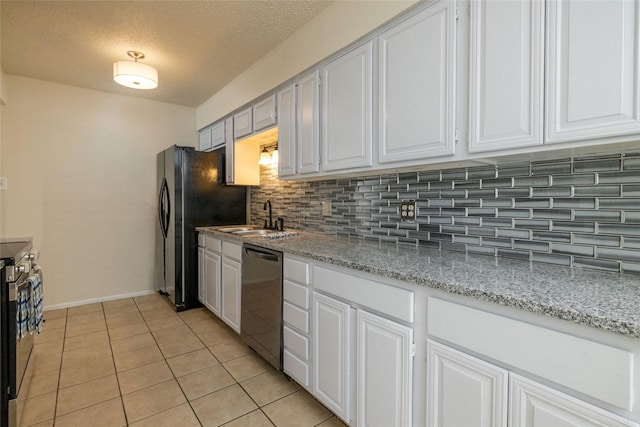 kitchen with black appliances, a sink, and white cabinets