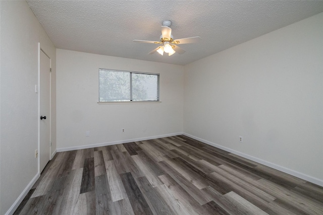 empty room with dark wood-style floors, ceiling fan, a textured ceiling, and baseboards