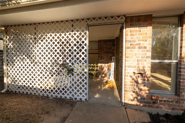 entrance to property featuring brick siding