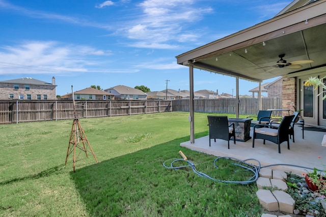 view of yard with ceiling fan, a patio area, and outdoor lounge area