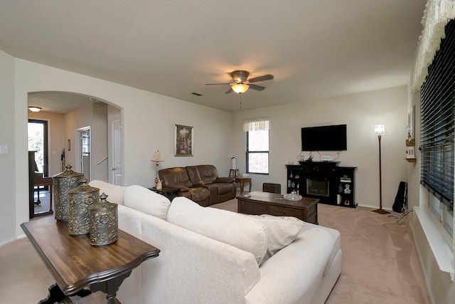 carpeted living room featuring ceiling fan and plenty of natural light