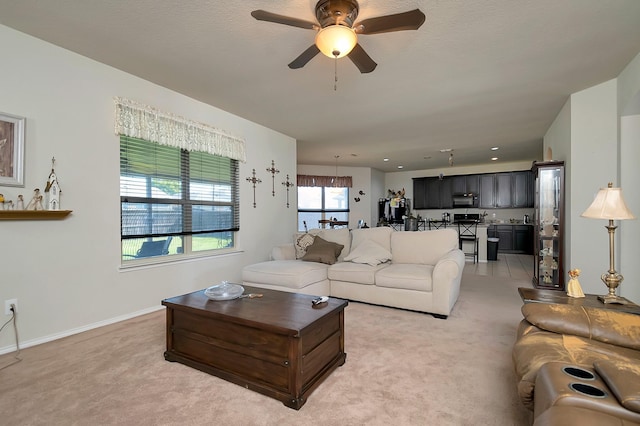 carpeted living room with ceiling fan