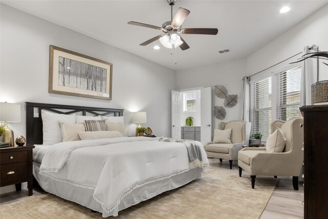 bedroom with ceiling fan and light hardwood / wood-style floors