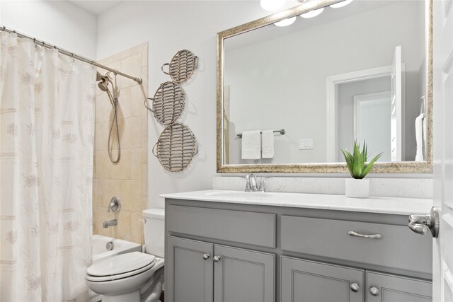 full bathroom with toilet, shower / bath combo with shower curtain, and vanity