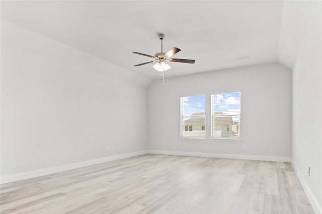 empty room featuring ceiling fan, lofted ceiling, and light hardwood / wood-style floors