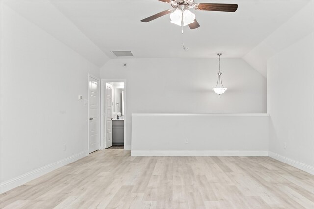 unfurnished room featuring ceiling fan, light wood-type flooring, and lofted ceiling