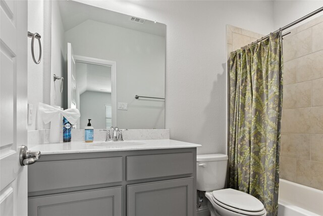 full bathroom featuring vanity, shower / bath combination with curtain, and toilet