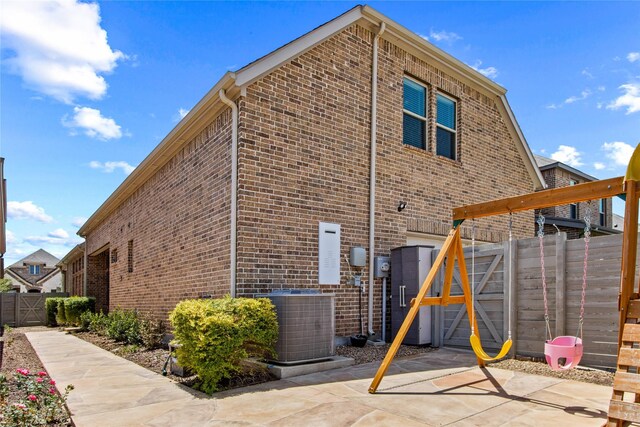 rear view of property with a patio area and central AC unit