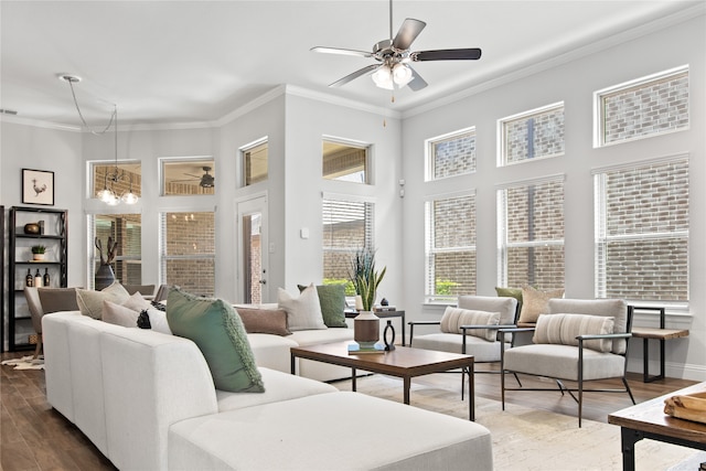 living room with hardwood / wood-style floors, crown molding, a high ceiling, and ceiling fan