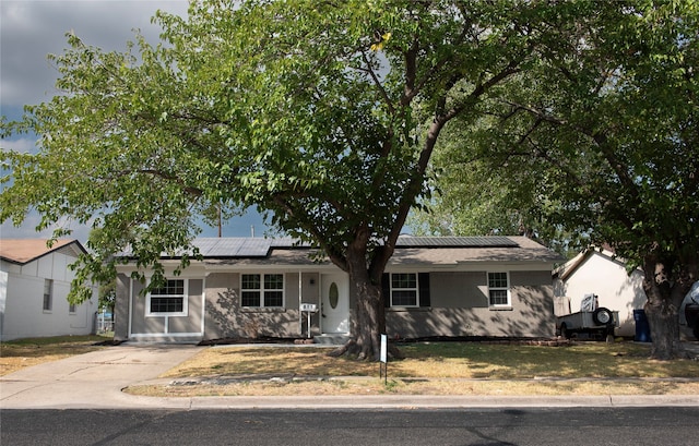 single story home with solar panels