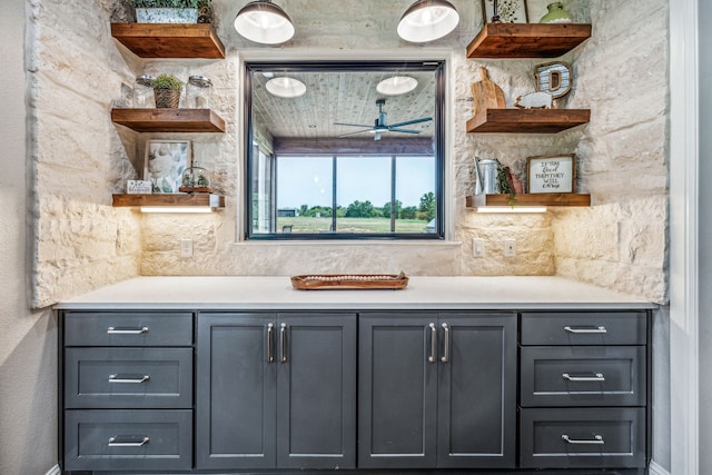 bar with ceiling fan and gray cabinets