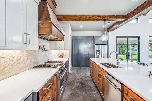 kitchen with custom exhaust hood, beamed ceiling, appliances with stainless steel finishes, and sink