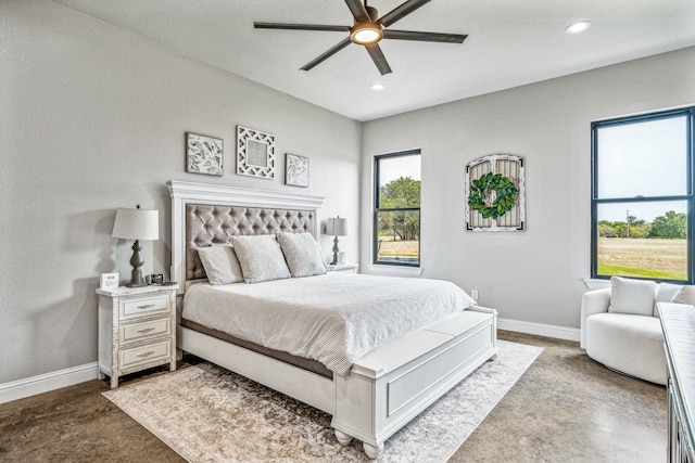 bedroom with ceiling fan and concrete floors