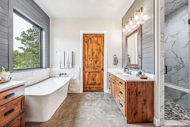 bathroom featuring plus walk in shower, tile walls, vanity, and concrete flooring