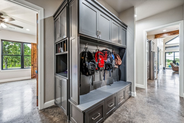 mudroom with ceiling fan and concrete flooring