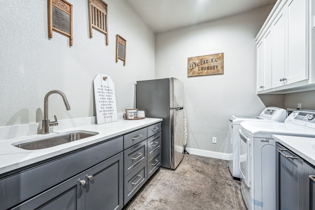 laundry area with cabinets, sink, and washer and dryer