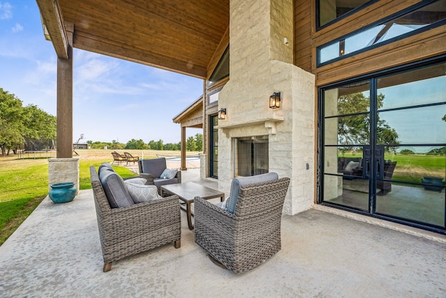 view of patio / terrace with an outdoor fireplace