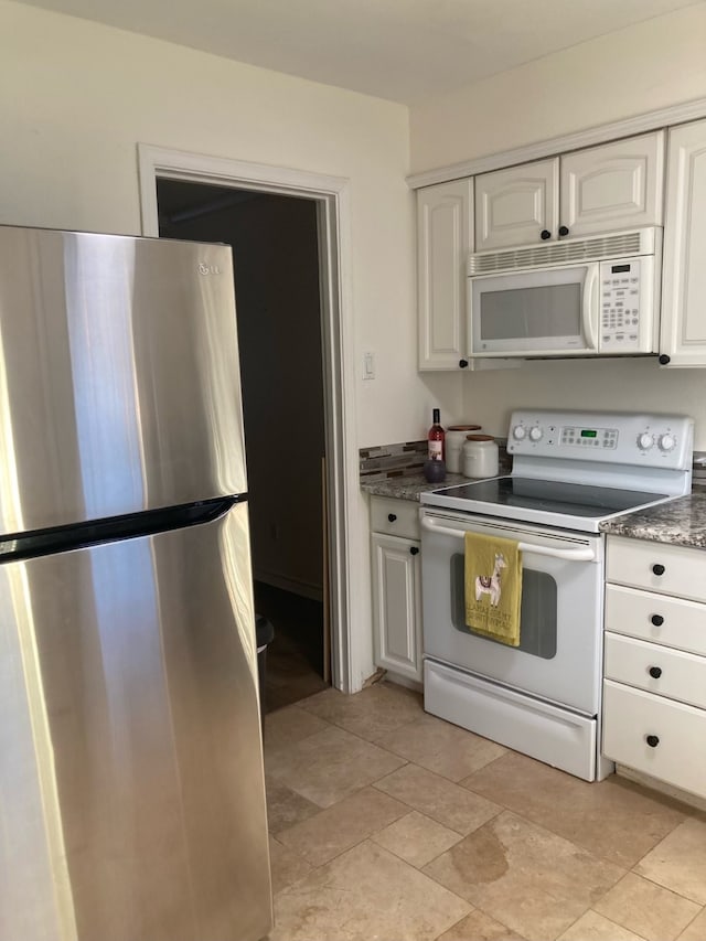 kitchen featuring white cabinets and white appliances