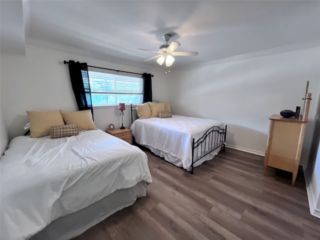 bedroom with dark wood-type flooring, ceiling fan, and ornamental molding