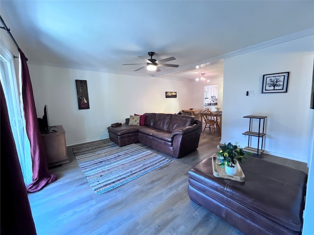 living room featuring hardwood / wood-style floors, ceiling fan, and ornamental molding