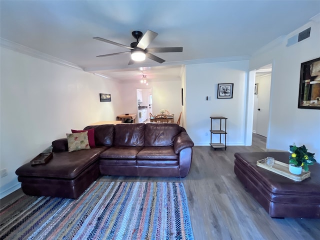 living room featuring wood-type flooring, ceiling fan, and crown molding