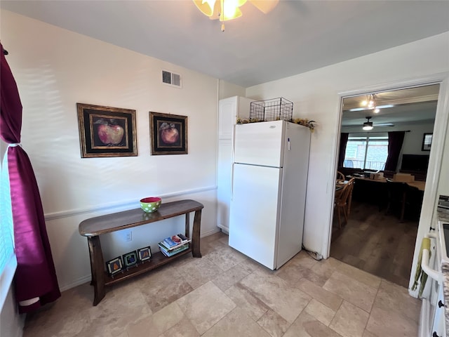 kitchen featuring white cabinetry, light wood-type flooring, ceiling fan, and white refrigerator