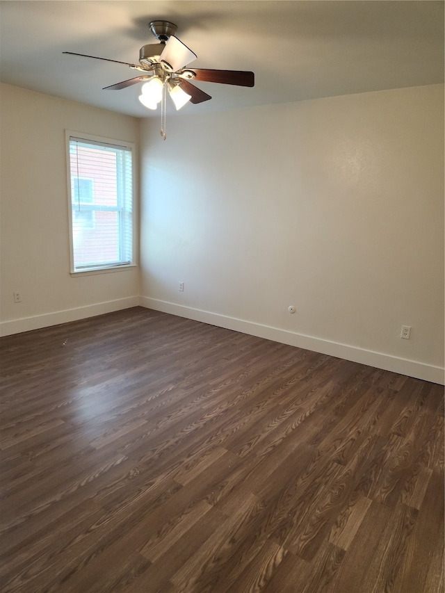 spare room featuring dark wood-type flooring and ceiling fan