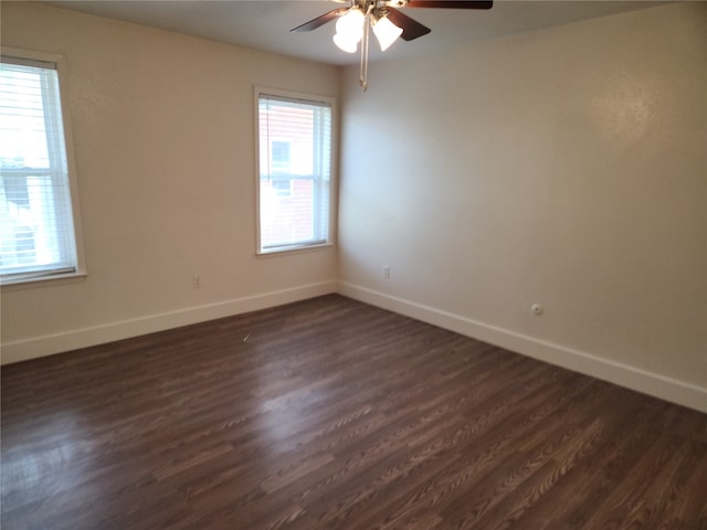 empty room with dark wood-type flooring and ceiling fan