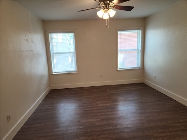 empty room with ceiling fan and dark hardwood / wood-style floors