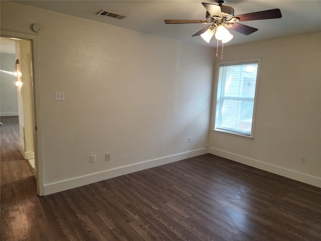 spare room featuring ceiling fan and dark wood-type flooring