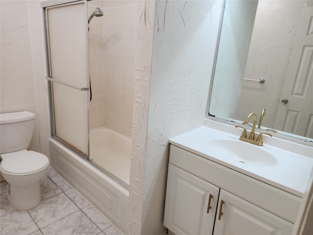 full bathroom with combined bath / shower with glass door, toilet, tile patterned floors, and vanity