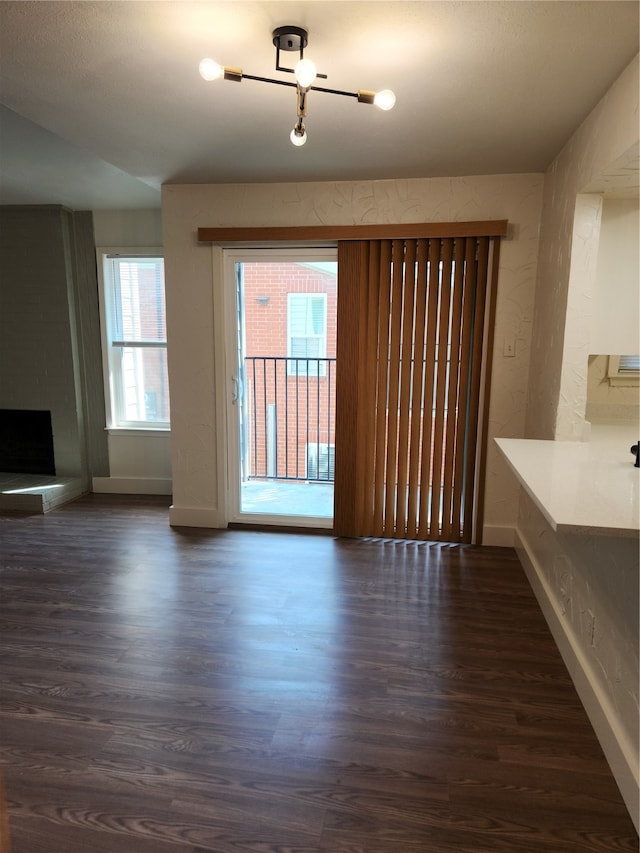 unfurnished living room with dark hardwood / wood-style floors