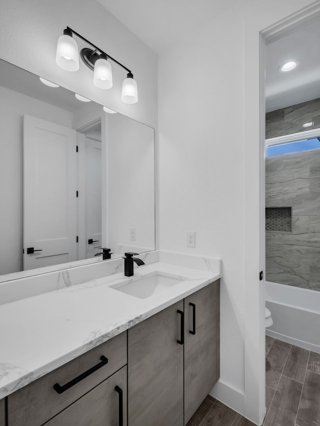 full bathroom with vanity, toilet, and tiled shower / bath combo