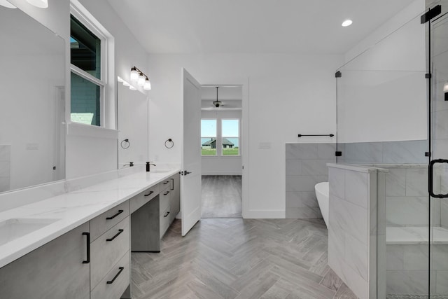 bathroom with vanity, parquet flooring, and plus walk in shower