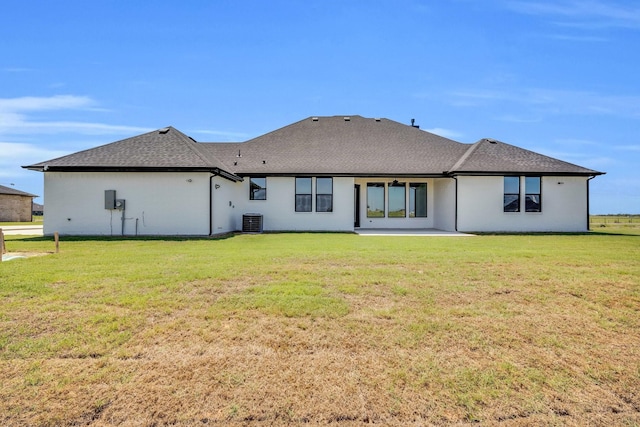 back of house featuring central AC, a lawn, and a patio area