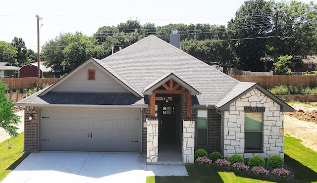 view of front of property with a front yard and a garage