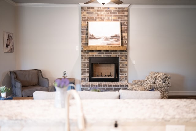 living room featuring ceiling fan, a fireplace, ornamental molding, and brick wall