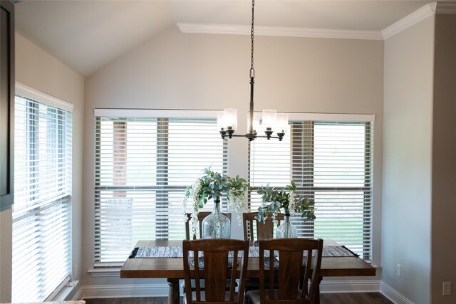 dining room featuring a notable chandelier, crown molding, dark hardwood / wood-style flooring, and vaulted ceiling