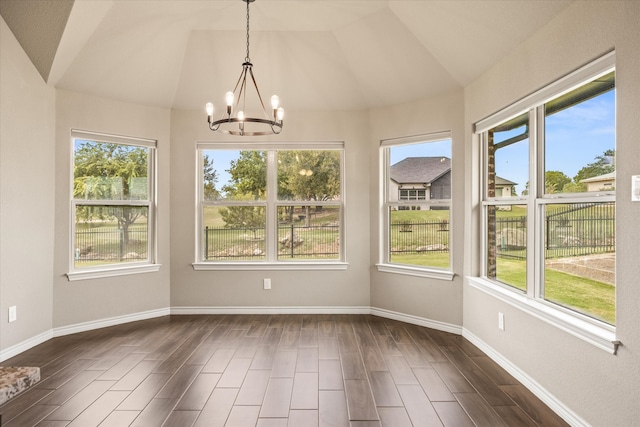 unfurnished dining area with lofted ceiling, a chandelier, and dark hardwood / wood-style flooring